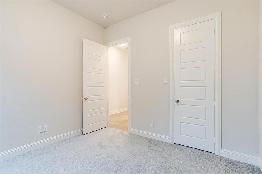 Unfurnished bedroom featuring light carpet