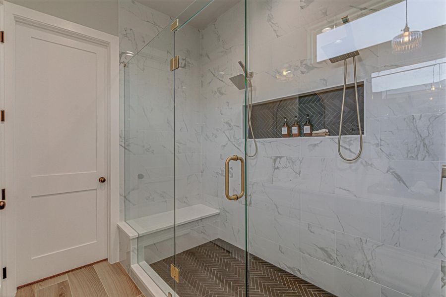 Full bath featuring a marble finish shower.