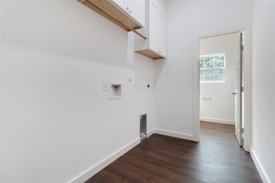 Laundry room on main level connecting to half bath