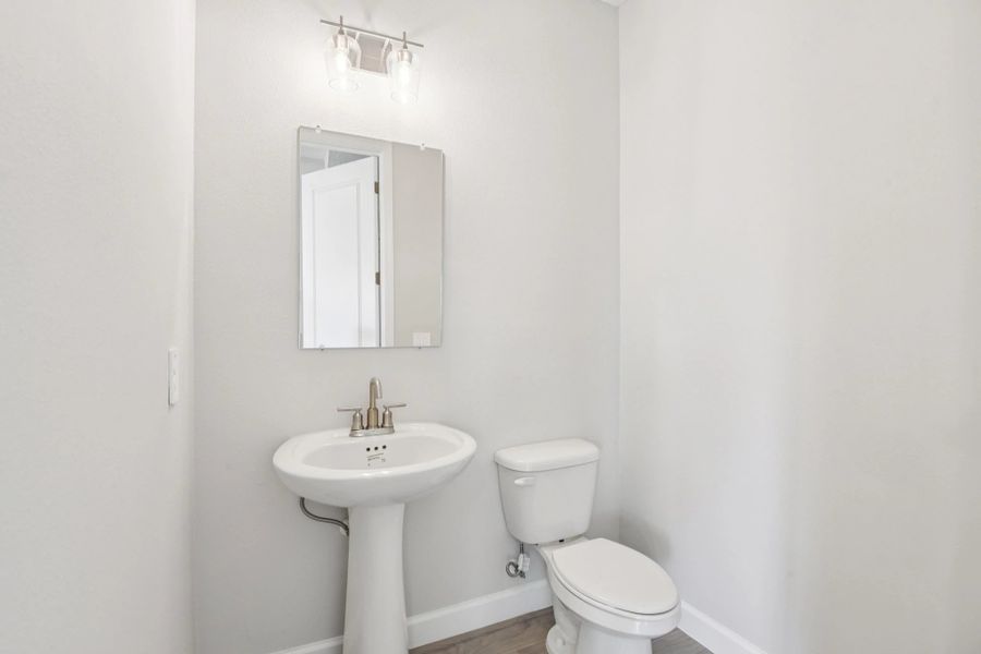 Half bathroom located off the kitchen near the garage