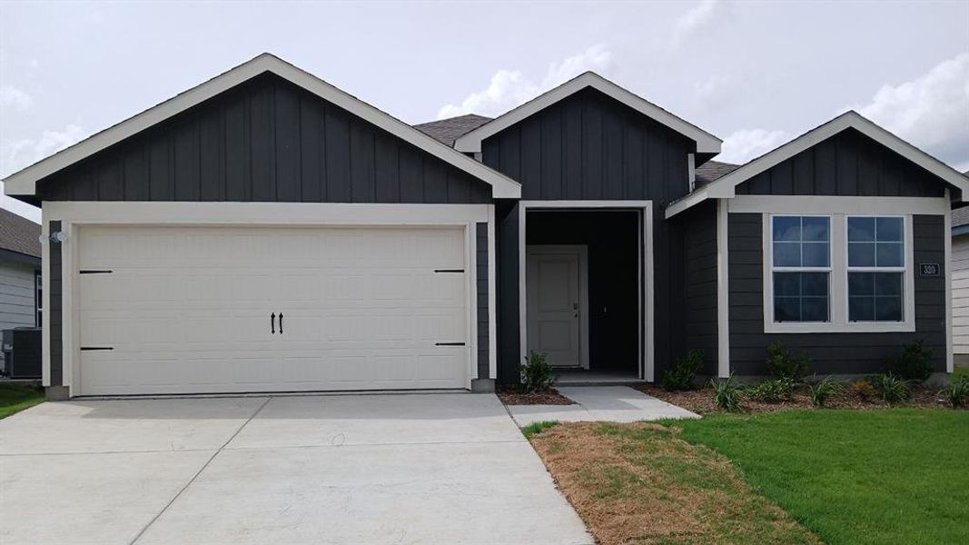 Contemporary single-story residence featuring dark siding with white trim accents Contemporary single-story residence featuring dark siding with white trim accents
