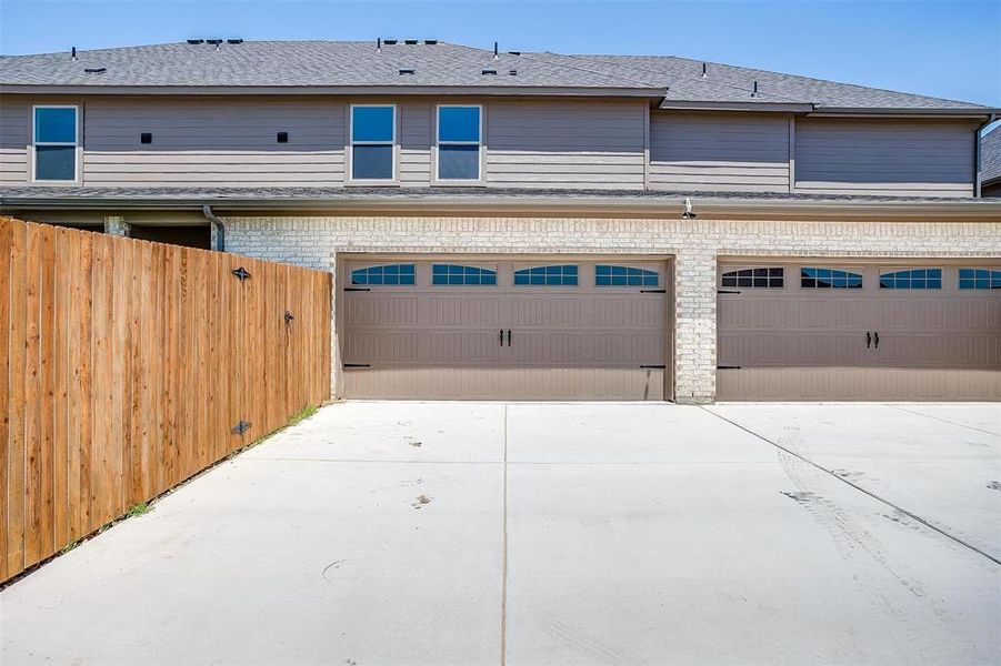 Garage featuring concrete driveway