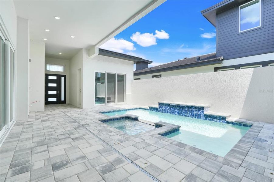 Exterior details and patio area of a home in Hampton Green at Providence, Davenport (Image 34).
