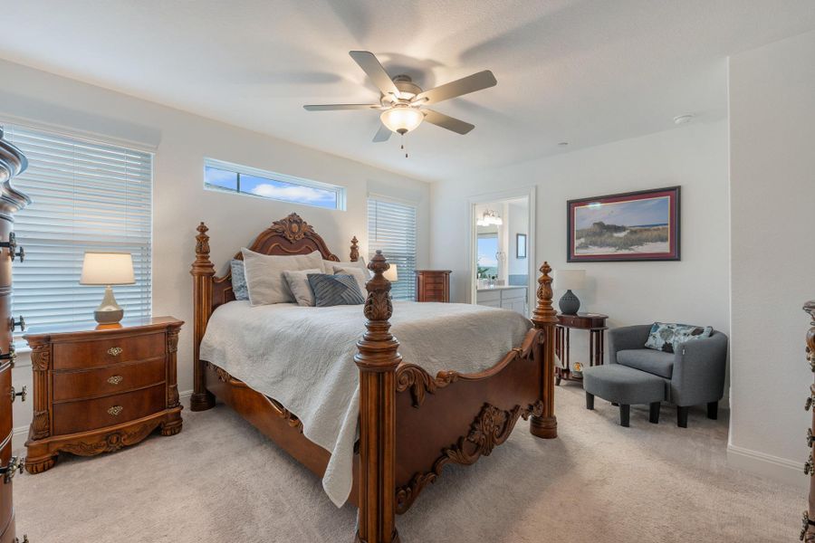 Well-lit sleeping quarters with a richly carved wooden bed and an adjoining private bath. Well-lit sleeping quarters with a richly carved wooden bed and an adjoining private bath.