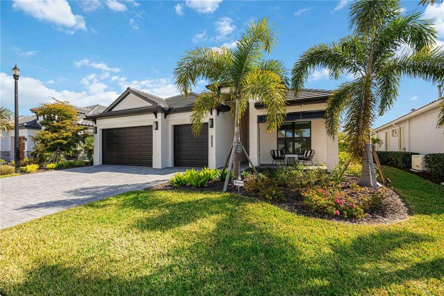 Front exterior of a new home in Gran Place, Venice, FL, highlighting curb appeal (Image 22).