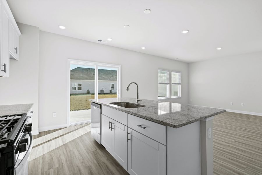 Enjoy preparing meals in this open kitchen with large work island. Enjoy preparing meals in this open kitchen with large work island.