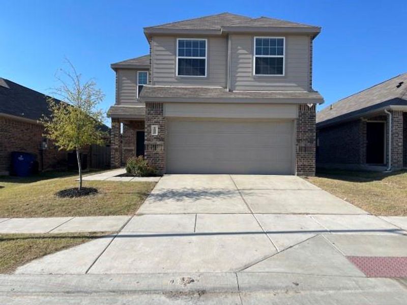 Front exterior of a new home in Christian Meadows, Ennis, TX, highlighting curb appeal (Image 1). Front exterior of a new home in Christian Meadows, Ennis, TX, highlighting curb appeal (Image 1).