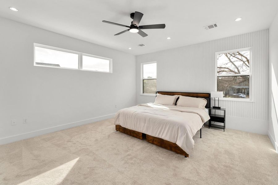 Bedroom with carpet, recessed lighting, a ceiling fan, and multiple windows