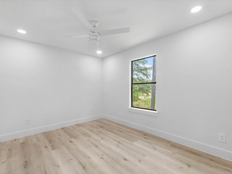 Fifth bedroom upstairs with a view of the side yard
