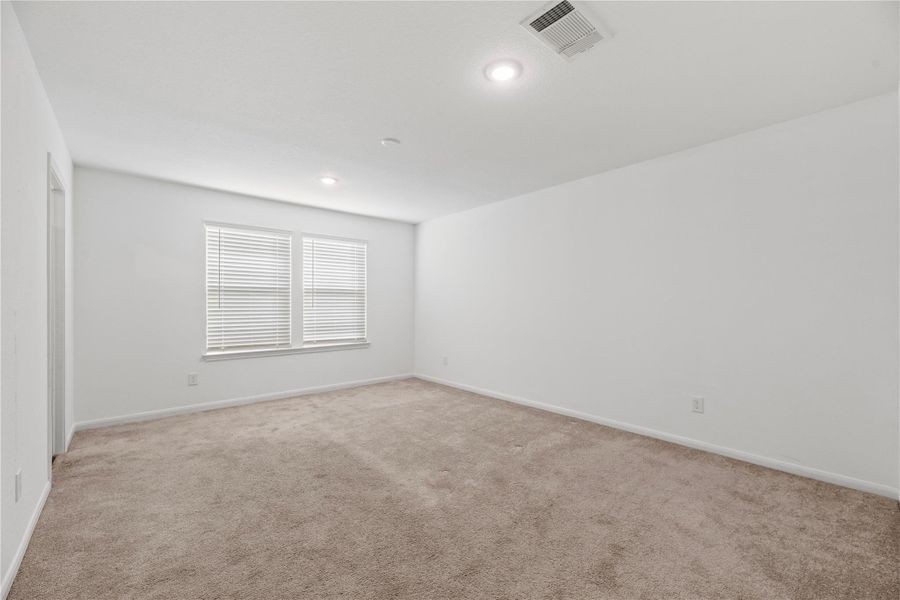 Primary bedroom with carpeted flooring and an en-suite bathroom. Primary bedroom with carpeted flooring and an en-suite bathroom.