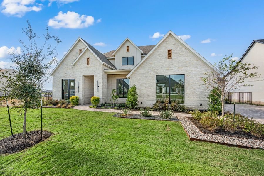 Front exterior of a new home in The Resort on Eagle Mt. Lake, Fort Worth, TX, highlighting curb appeal (Image 27).