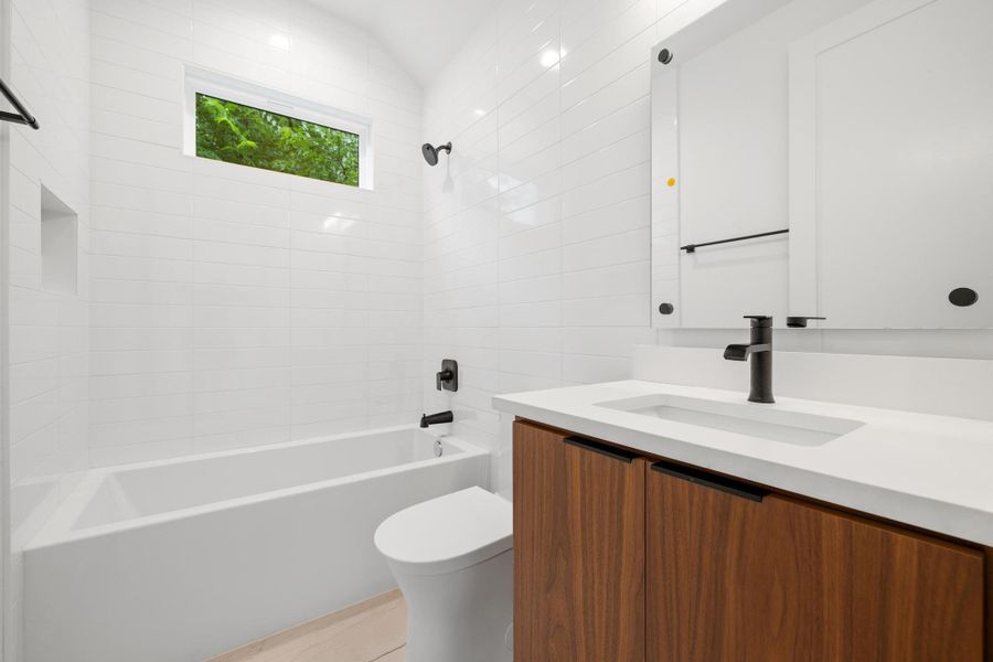 Full bathroom with vanity and shower / bath combination Full bathroom with vanity and shower / bath combination