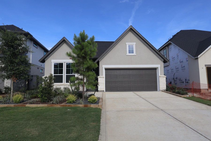 Front exterior of a new home in Woodson’s Reserve, Spring, TX, highlighting curb appeal (Image 2). Front exterior of a new home in Woodson’s Reserve, Spring, TX, highlighting curb appeal (Image 2).