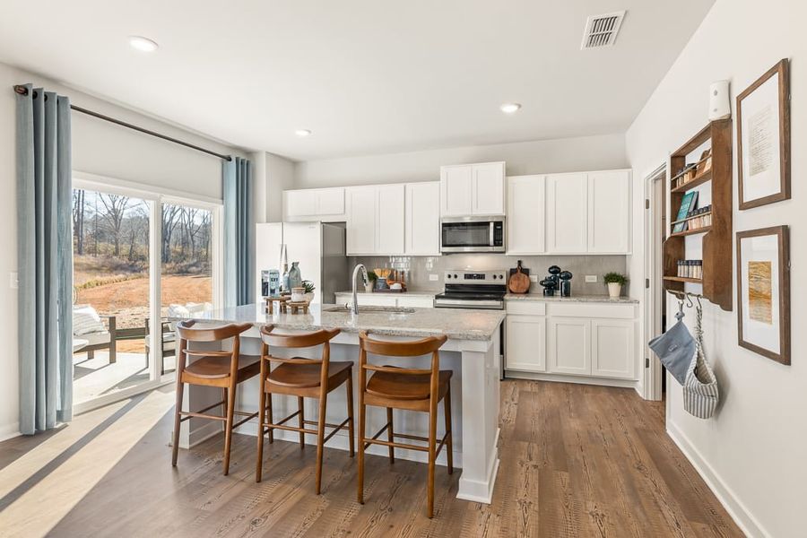 A kitchen with a dining table and chairs. A kitchen with a dining table and chairs.