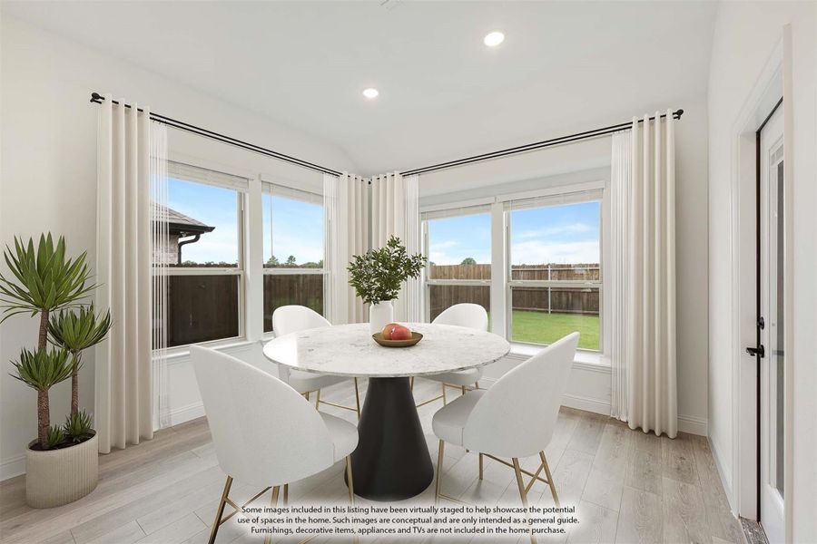 Bright dining area with round marble table, white chairs, large windows, and light wood floors