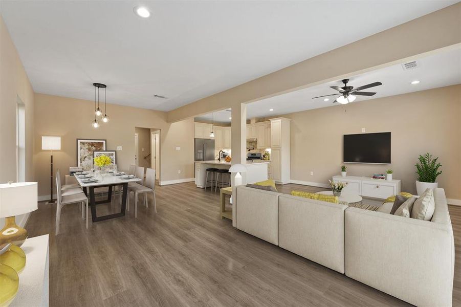 The home boasts a spacious, open floor plan where the expansive living area seamlessly flows into the kitchen, creating a perfect space for both relaxing and entertaining.