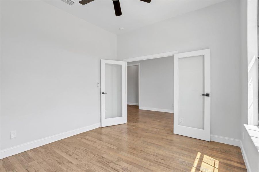 Unfurnished bedroom featuring ceiling fan and light hardwood / wood-style flooring