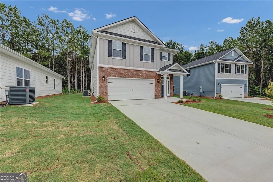 Front exterior of a new home in Canterbury Villas, Carrollton, GA, highlighting curb appeal (Image 22). Front exterior of a new home in Canterbury Villas, Carrollton, GA, highlighting curb appeal (Image 22).