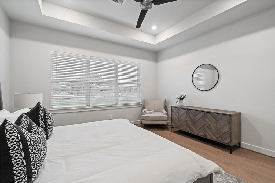 Generously sized primary suite with clean wall lines and a wide rear window that brings in steady natural light, keeping the space open and relaxed without feeling crowded.