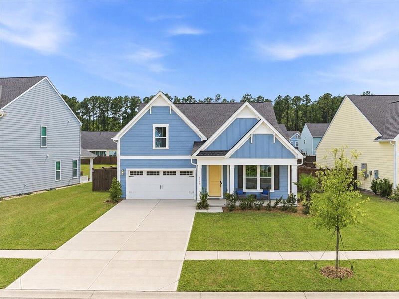 Front exterior of a new home in Homecoming, Ravenel, SC, highlighting curb appeal (Image 27). Front exterior of a new home in Homecoming, Ravenel, SC, highlighting curb appeal (Image 27).