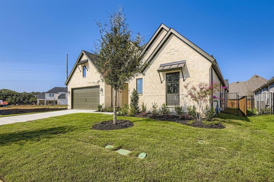 View of front of property with brick siding and concrete driveway