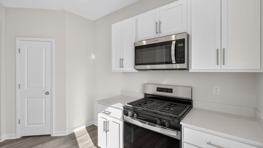Representative furnished interior of a home built from the NEWTON by D.R. Horton in The Townes at Galvins Ridge, Sanford (Image 4).