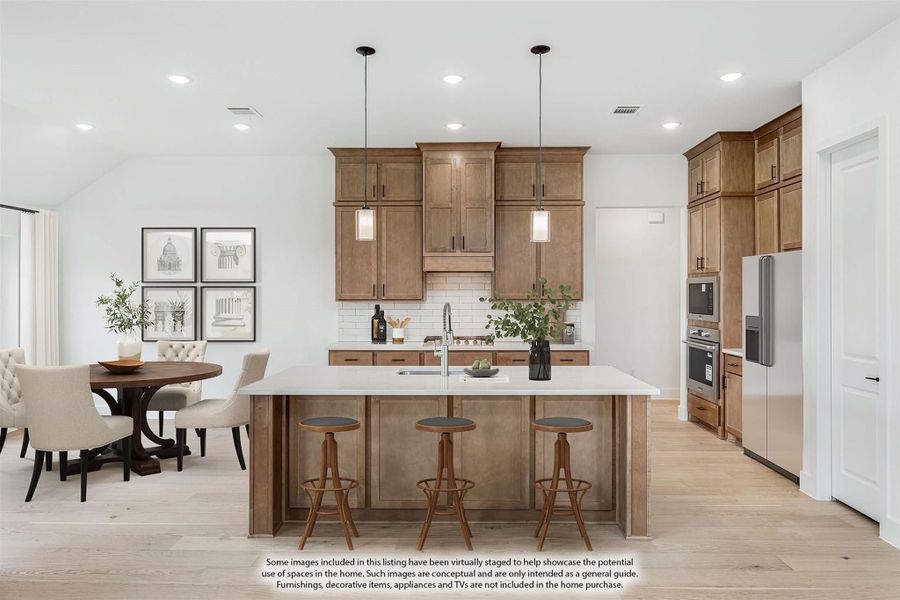 Kitchen with large island, wood cabinets, white countertops, and adjacent dining area with round table Kitchen with large island, wood cabinets, white countertops, and adjacent dining area with round table