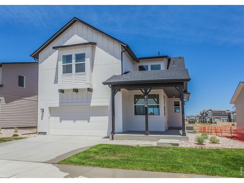 Front exterior of a new home in Trailside, Timnath, CO, highlighting curb appeal (Image 2). Front exterior of a new home in Trailside, Timnath, CO, highlighting curb appeal (Image 2).