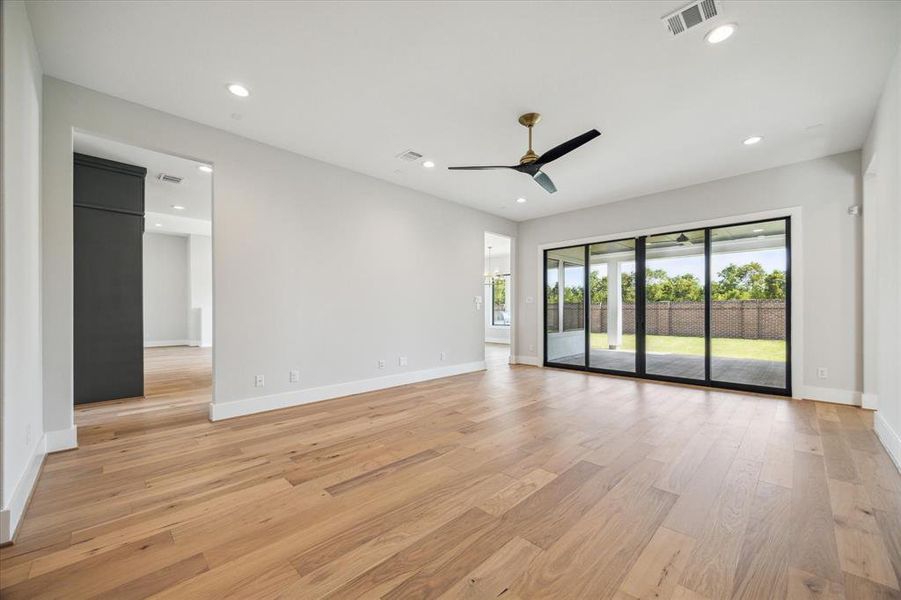 Gameroom with a sliding wall of windows that opens to the covered patio.