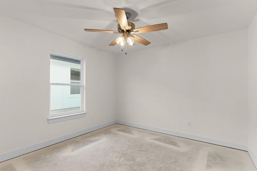 Spare room with concrete floors and ceiling fan Spare room with concrete floors and ceiling fan