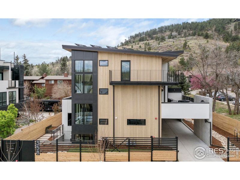 Exterior view of 358 Arapahoe Ave from Arapahoe, framed by Flagstaff Mountain in the background. The Viewpoint Trailhead is just moments away.