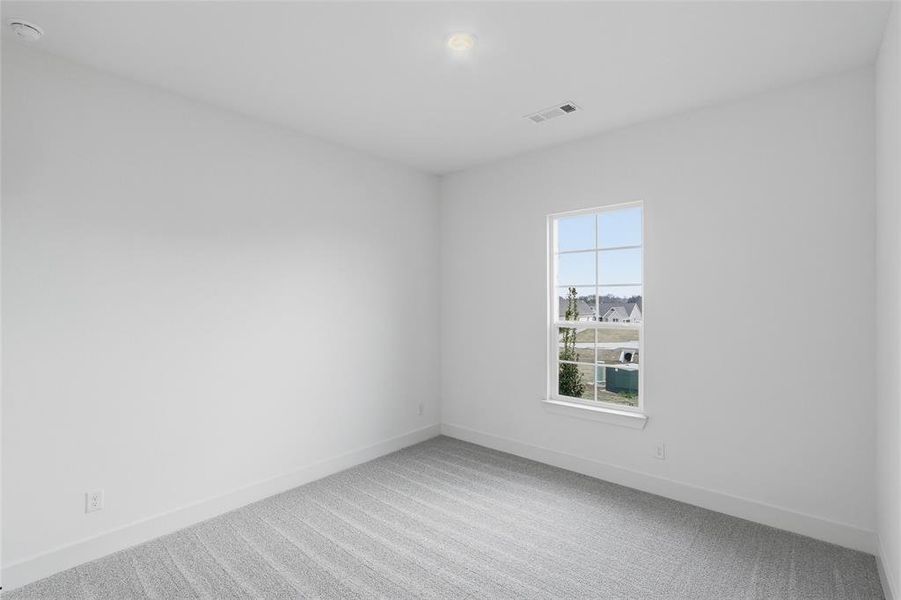 Unfurnished room with light carpet and baseboards