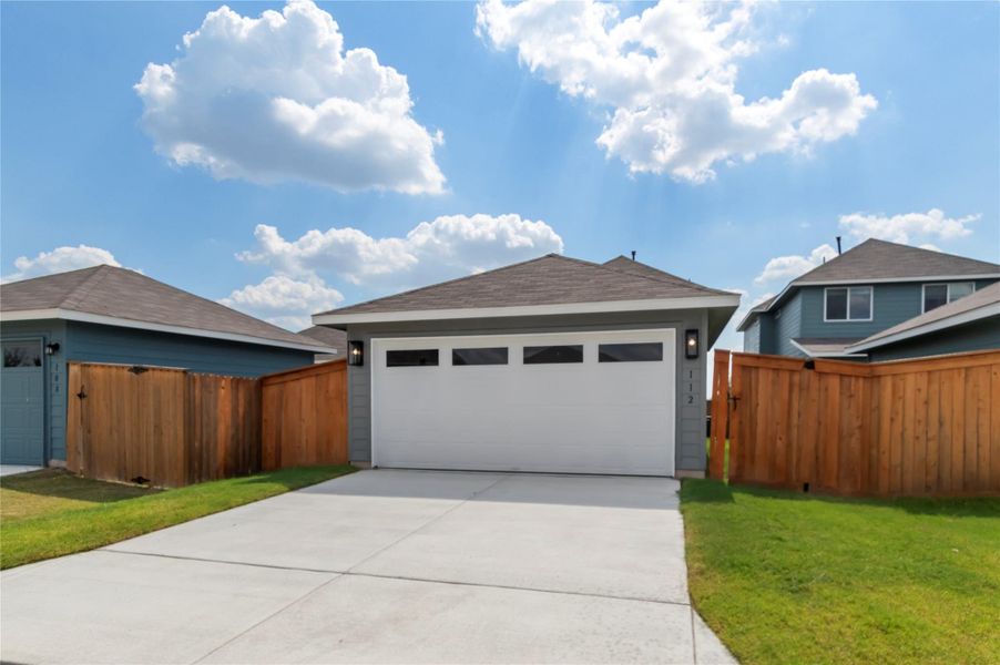 View of front of property with a garage, driveway, and a shingled roof View of front of property with a garage, driveway, and a shingled roof