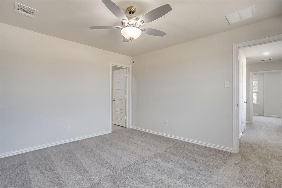 Spare room with light colored carpet and ceiling fan