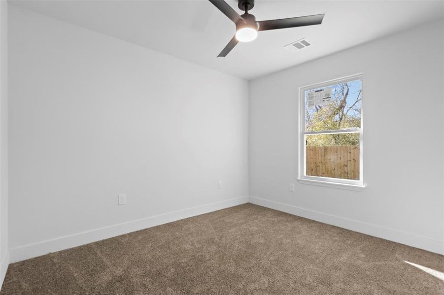 Unfurnished room featuring carpet flooring and ceiling fan