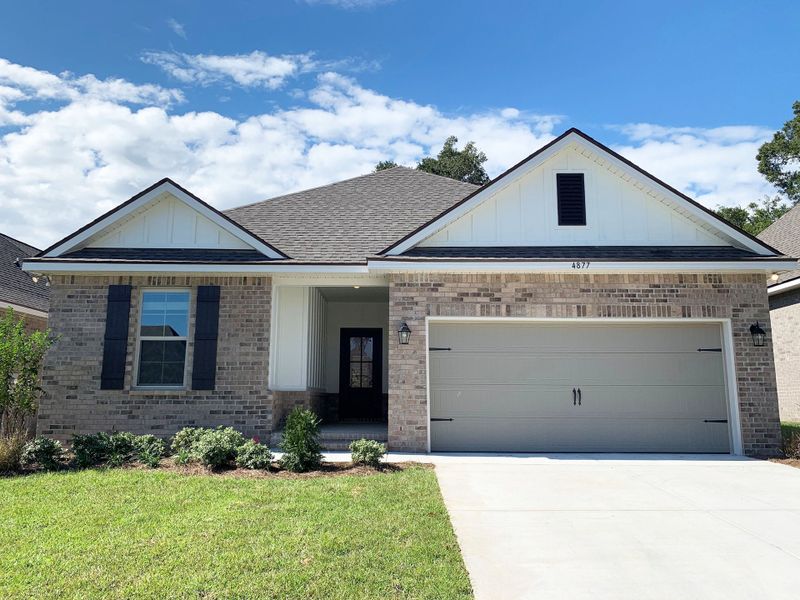 Front exterior of a new home in Sentinel Ridge, Pace, FL, highlighting curb appeal (Image 1).