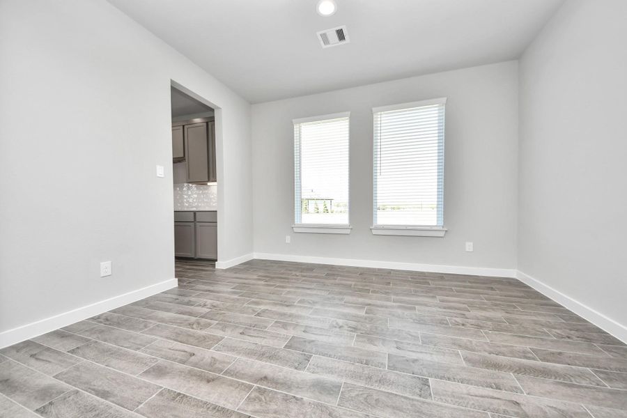 Craft enduring memories with loved ones around the table in this roomy dining area. It boasts stylish flooring, personalized paint, and is conveniently situated next to the family room and kitchen, fostering an open and inclusive ambiance. Sample photo of completed home with similar floor plan. Actual colors and selections may vary. Craft enduring memories with loved ones around the table in this roomy dining area. It boasts stylish flooring, personalized paint, and is conveniently situated next to the family room and kitchen, fostering an open and inclusive ambiance. Sample photo of completed home with similar floor plan. Actual colors and selections may vary.