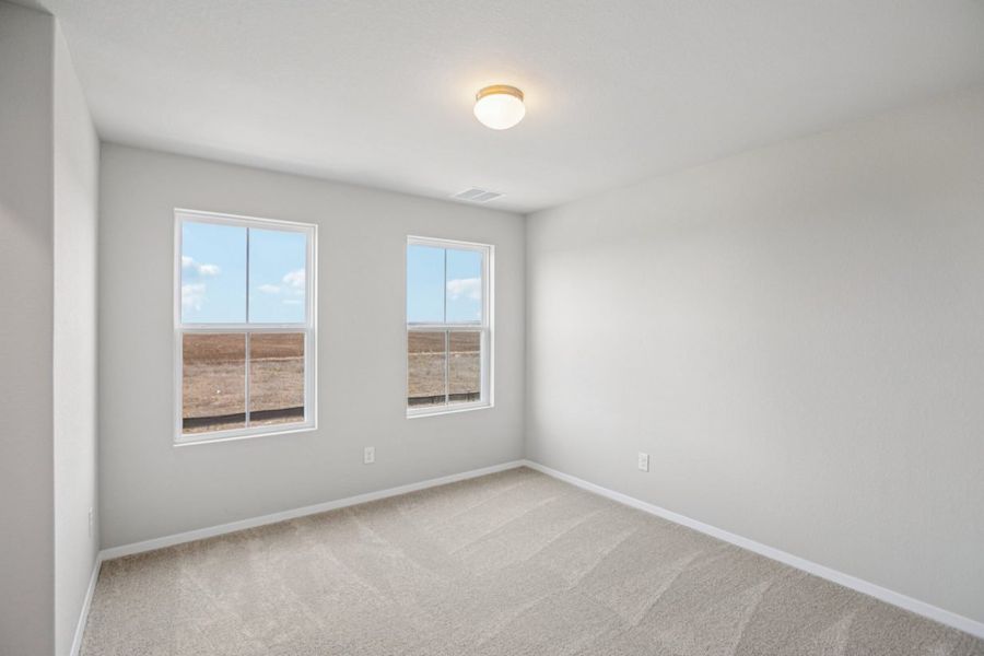Image of a bedroom with light grey walls, tan carpeting, two windows and white trim Image of a bedroom with light grey walls, tan carpeting, two windows and white trim