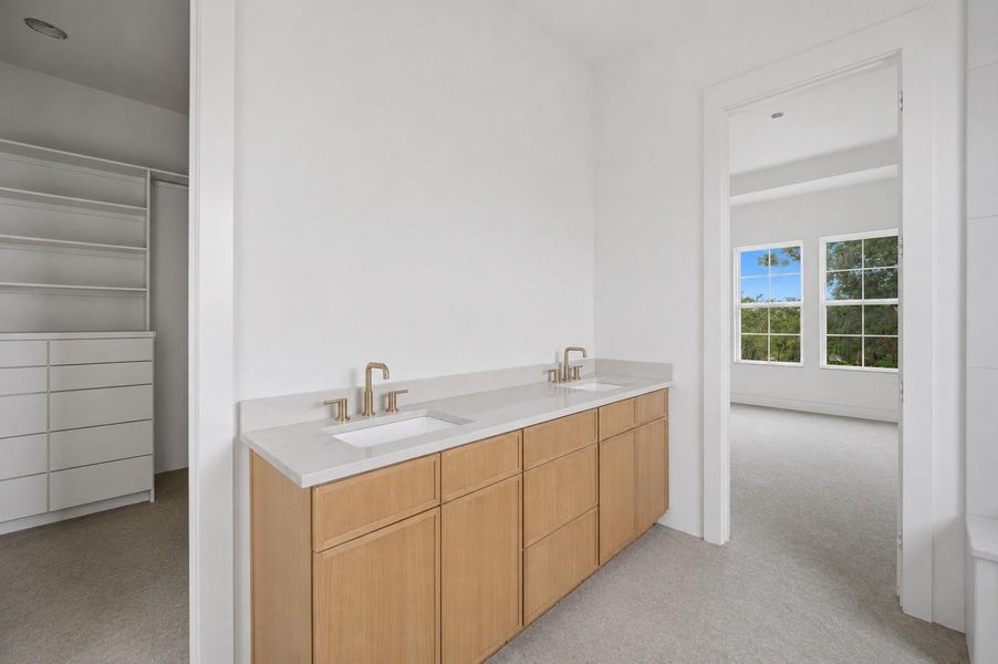 Dual vanities in primary bathroom with quartz countertops Dual vanities in primary bathroom with quartz countertops