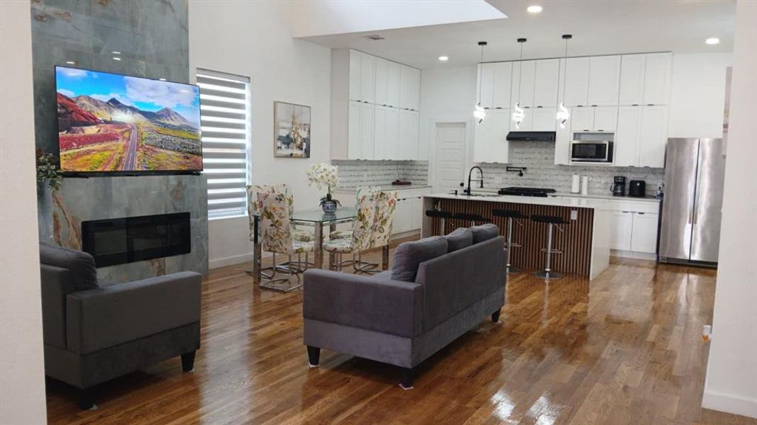Open-concept living space featuring hardwood flooring throughout