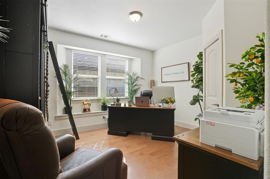 Home office with light wood-style flooring and baseboards Home office with light wood-style flooring and baseboards