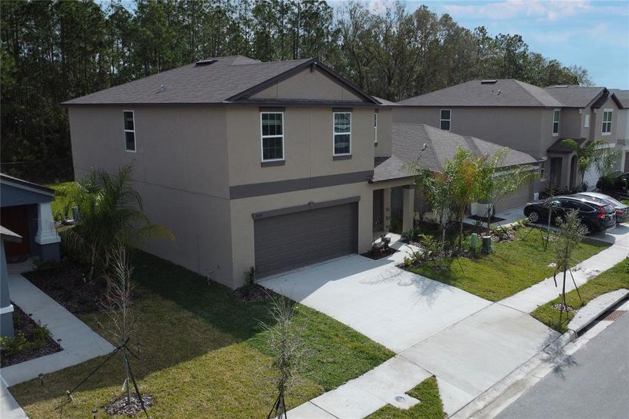 Front exterior of a new home in Saddle Creek Preserve: The Manors II, Lakeland, FL, highlighting curb appeal (Image 26).