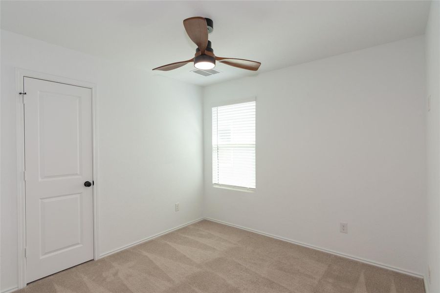 Neutral tone wall paint with wood-finish ceiling fan and integrated lighting