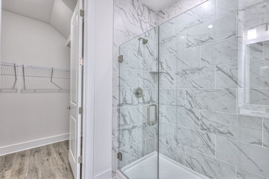 The primary bathroom offers dual vanity sinks and a walk-in shower. The primary bathroom offers dual vanity sinks and a walk-in shower.