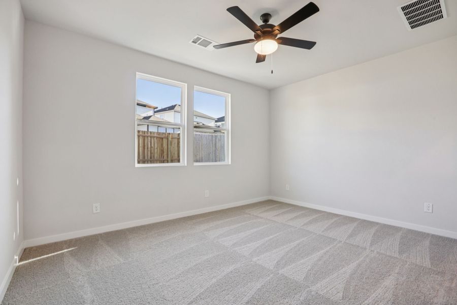 A room with a ceiling fan and a window.