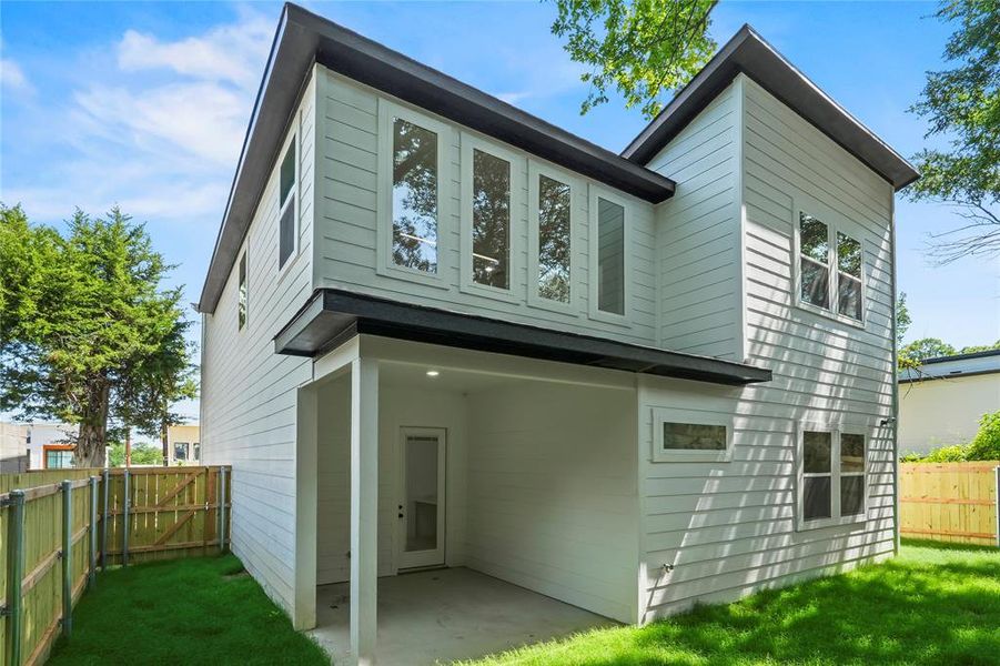 Back of property with a patio and a gate