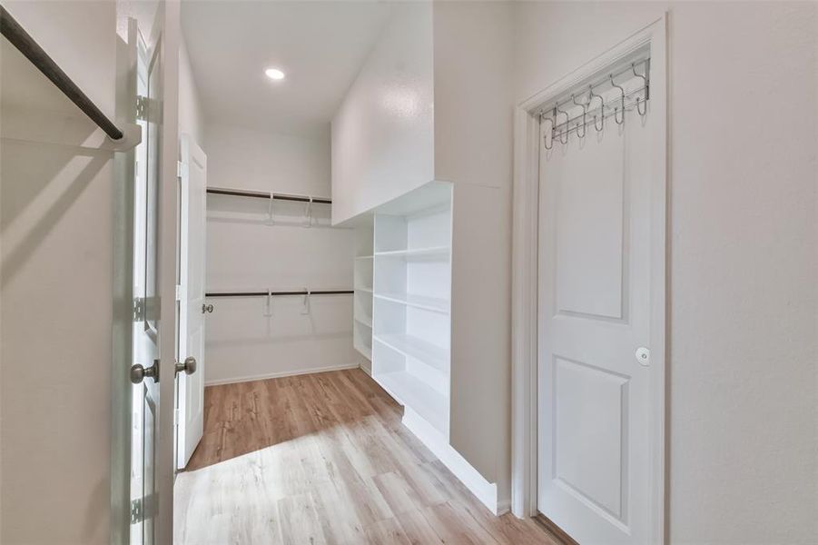 *California Closets* custom closet also includes door for quick and easy access to laundry room!