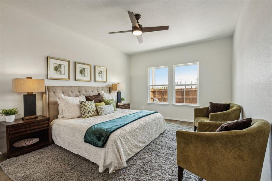 Bedroom featuring wood-type flooring and ceiling fan