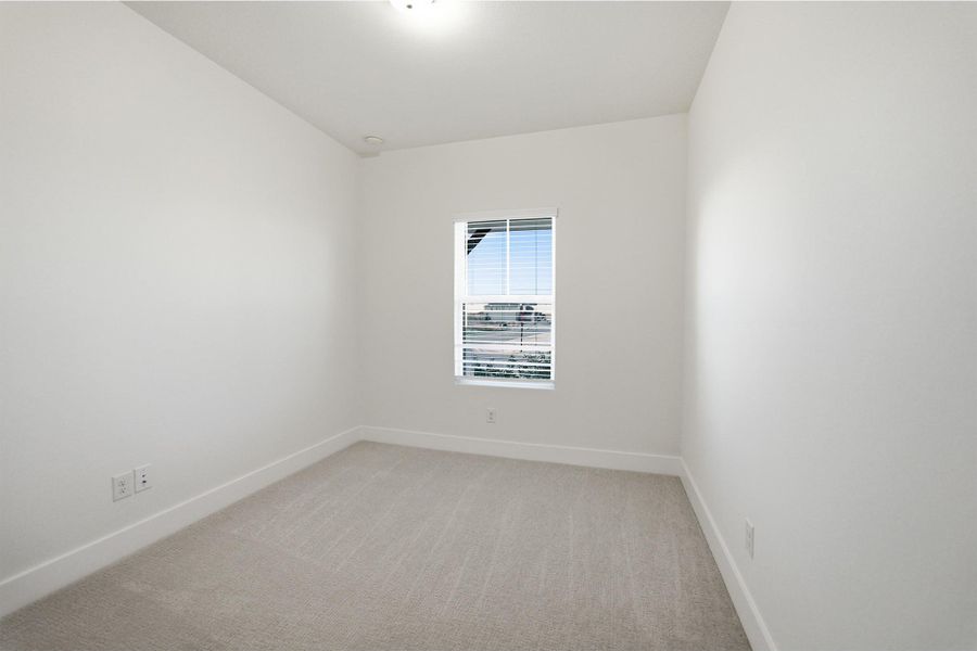 Unfurnished room with light colored carpet and baseboards