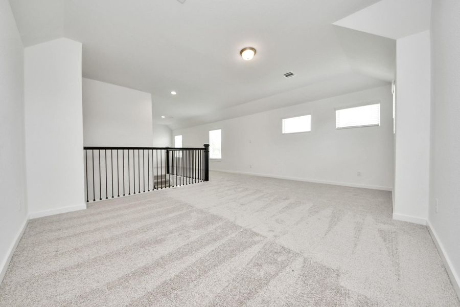 Come upstairs and enjoy a day of leisure in this fabulous game room! This is the perfect hangout spot or adult game room! Features plush carpet, high ceilings, custom paint and windows for plenty of natural light. Come upstairs and enjoy a day of leisure in this fabulous game room! This is the perfect hangout spot or adult game room! Features plush carpet, high ceilings, custom paint and windows for plenty of natural light.